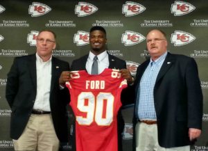 May 9, 2014; Kansas City, MO; Chiefs GM John Dorsey, OLB Dee Ford (90) and coach Andy Reid during Ford's introductory press conference.  Credit: Teope