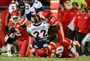 Nov 30, 2014; Kansas City, MO; Chiefs inside linebacker James-Michael Johnson (52), defensive end Allen Bailey (97) and outside linebacker Justin Houston (50) combine to tackle Broncos running back C.J. Anderson (22) at Arrowhead Stadium. Credit: Ron Chenoy-USA TODAY Sports 