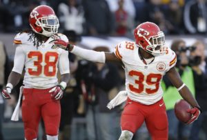 Kansas City Chiefs defensive back Husain Abdullah (39) signals after recovering a fumble by Oakland Raiders' Taiwan Jones during the third quarter of an NFL football game in Oakland, Calif., Sunday, Dec. 15, 2013. At right is Chiefs' Ron Parker (38). (AP Photo/Marcio Jose Sanchez)