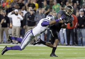 Kansas State defensive back Randall Evans (15) breaks up a pass intended for Baylor's Corey Coleman (1) in the first half of an NCAA college football game, Saturday, Dec. 6, 2014, in Waco, Texas. (AP Photo/Tony Gutierrez)