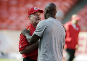 Aug. 23, 2014; Kansas City, MO; Chiefs spread game analyst/special projects coach Brad Childress (left) greets Minnesota Vikings running back Adrian Peterson (right) before a preseason game at Arrowhead Stadium. (AP Photo/Charlie Riedel)
