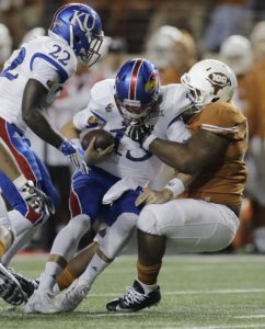 Nov. 7, 2015; Austin, TX; Texas defensive tackle Desmond Jackson sacks Kansas quarterback Ryan Willis at Darrell K. Royal–Texas Memorial Stadium. (AP Photo/Eric Gay)